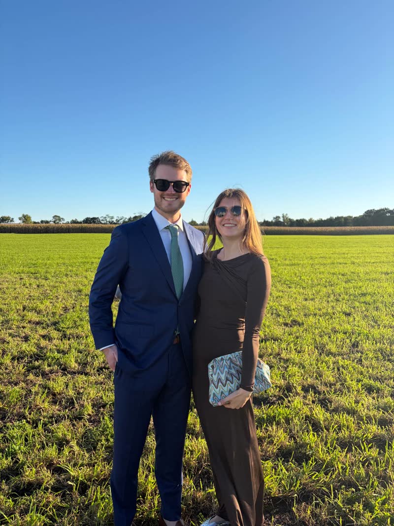 Chad and Anna in a field at golden hour